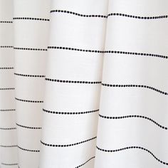 a white curtain with black dots on it