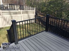 a deck with black iron railings and rails