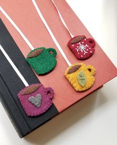 there are four felt pieces on the book cover, each with different colors and shapes