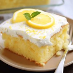 a slice of lemon cake on a plate with a fork