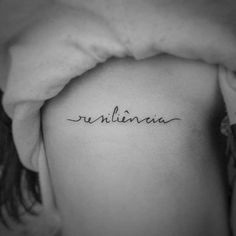 the back of a woman's shoulder with her name written in cursive writing