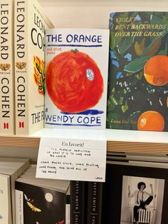 there are many books on the shelves in the library, including oranges and other children's books