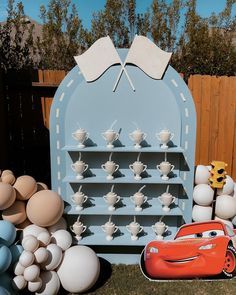 the cars birthday party is ready to be filled with balloons and decorations, including an egg carton