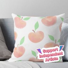 an apple pillow sitting on top of a couch with the words support independent artists above it