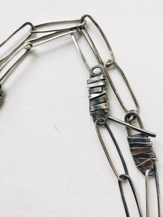 "Large sterling silver link chain necklace, made with rectangular and flat links. Some links have a \"bandage\" pattern, that is, I have covered them with a flattened hammered wire and welded to the base. The closure is T- toggle, the necklace can also be worn in the short version with 2 rounds around the neck. The finished piece was subjected to a burnishing process and subsequently polished to enhance the most exposed parts. Open length 95 cm, closed 45 cm weight 42 g The craftsmanship makes t Modern Handmade Jewelry With Rectangular Links, Modern Silver Necklace With Rectangular Links, Modern Handmade Link Chain Necklace, Modern Silver Necklace With Hooks And Links, Metal Necklaces With Rectangular Links, Modern Sterling Silver Chain Necklace With Rectangular Links, Silver Chain Necklace With Rectangular Links, Handmade Sterling Silver Necklace With Rectangular Links, Silver Metal Chain Necklace With Rectangular Links