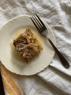 a piece of cake on a plate with a fork and napkin in front of it