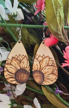 wooden earrings with an image of a sunflower on the front and back of them