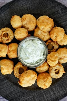 fried mushrooms on a plate with ranch dip in the middle and text overlay that reads vegan's roadhouse fried mushrooms