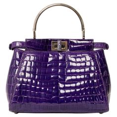 Borsa firmata Fendi, modello Peekaboo, misura mini, reaizzat in pelle viola con hardware argentati. Dotata di una doppia chiusura a girello fronte retro, internamente rivestita in pelle liscia viola, capiente per l’essenziale. Munita di un manico centrale rigido per portata a mano, e di una tracolla sottile in pelle cocco, rimovibile e regolabile. Caratterizzata da bottoni ad incastro laterali e da piccola tasca interna con chiusura a zip. Si presenta in ottime condizioni. ______________________ Fendi Peekaboo Mini, Chanel Coco Handle, French Top, Fendi Casa, Louis Vuitton Limited Edition, Fendi Peekaboo, Vintage Fendi, Suede Tops, Togo Leather