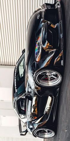 a black sports car parked in front of a building