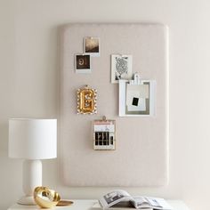 a white desk topped with pictures and a lamp