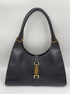 A stunning vintage Gucci Jackie bag made from textured black leather with gold hardware. Inside the bag is lined with a very special gold nylon lining and there is a zipped pocket for valuables. This bag is in very good vintage condition. There are some slight wrinkles on the leather and minor wear to be seen on the gold hardware. A true collectors item, increasingly hard to find the vintage Jackie bag's with gold hardware. Vintage Gucci Jackie, Gucci Jackie Bag, Vintage Gucci, Wallet Case, Bag Making, Gold Hardware, Luxury Bags, Wrinkles, Fashion Bags