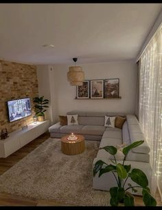 a living room filled with furniture and a flat screen tv