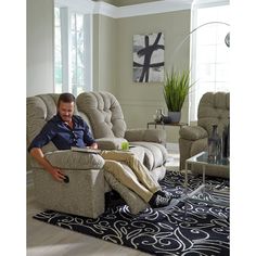 a man sitting in a recliner reading a book