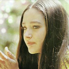 a woman with long hair holding a cell phone