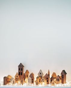 a group of wooden houses sitting on top of a shelf