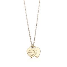 Inspired by the iconic key ring first introduced in 1969, the Return to Tiffany collection is a classic reinvented. A delicate duo of engraved tags on a simple link chain exudes sophistication and elegance. 18k gold; On a 16" chain | Return To Tiffany® Double Heart Tag Pendant in Yellow Gold, Mini, Size: 16 in. Return To Tiffany Necklace, Tiktok Slideshow, Heart Necklace Tiffany, Tiffany Gold, Tiffany And Co Necklace, Pendants Gold, Return To Tiffany, Tiffany Necklace, Double Heart Necklace