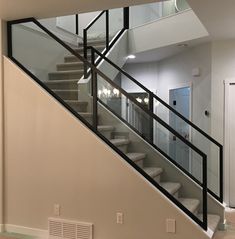 a stair case with glass railings in a house