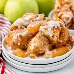 two white plates topped with apple cinnamon rolls