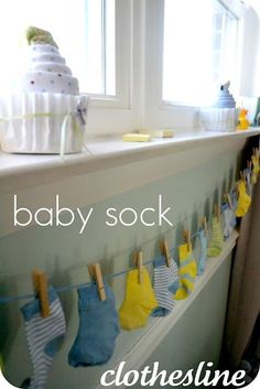 baby socks hanging on clothesline next to window