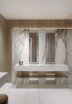 a modern bathroom with marble walls and flooring