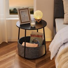 a small table with magazines and a lamp on it