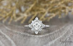 an engagement ring with a pear shaped diamond center