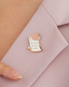 a person wearing a pink shirt and holding a pin