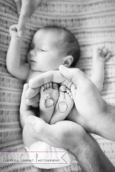 a person holding a baby in their hands