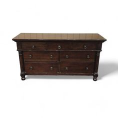 an old wooden dresser with many drawers and knobs on the bottom drawer, against a white background