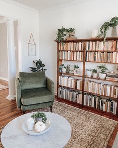 a living room filled with furniture and bookshelves