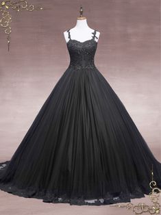 a black dress is on display in front of a mannequin headdress