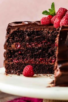 a slice of chocolate cake with raspberries on top