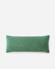 a green pillow on a white background