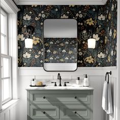 a bathroom with floral wallpaper and two sinks in front of a large mirror on the wall