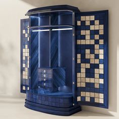 a bathroom with blue and gold tiles on the walls, including a stand up shower