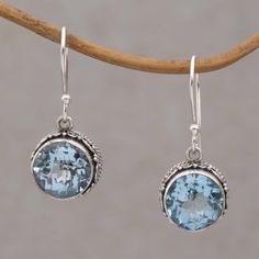 Faceted circle blue topaz stones totaling five carats are featured in this pair of dangle earrings from Bali. Framed with intricate sterling silver motifs the stones adorn the ears on hooks. This iridescent accessory is presented by Komang Wijayana. Blue Round Faceted Jewelry, Blue Round Faceted Earrings, Blue Round Sterling Silver Crystal Earrings, Nickel-free Blue Teardrop Crystal Earrings, Fashion Skirts, Blue Multi-stone Cubic Zirconia Earrings, Topaz Color, Blue Topaz Stone, Blue Topaz Earrings