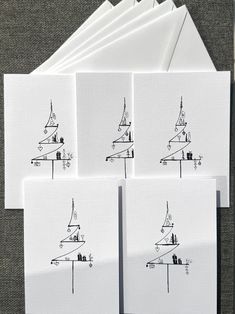 four cards with drawings of buildings on them