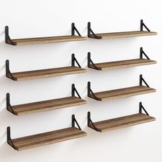 six wooden shelves with black metal brackets on them