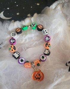 Halloween Colourful Beaded Bracelet - Drunk Pumpkin Made with Clay Beads and Metal Charm. Fits Most Wrists, As Its A Pull on and No Clasp Bracelet. Comes with Organza Bag For Storage White Beaded Bracelets For Halloween, Handmade White Beaded Bracelets For Halloween, Halloween Novelty Multicolor Beaded Bracelets, Handmade Halloween Festival Bracelets, Novelty Multicolor Beaded Bracelets For Halloween, Handmade Halloween Festival Bracelet, Adjustable Multicolor Beaded Bracelets For Halloween, Halloween Novelty Beaded Bracelets With Round Beads, Halloween Multicolor Beaded Bracelets