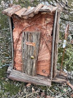 a small wooden structure with a door in it