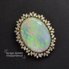 This one of a kind Australian Opal diamond pendant features a beautiful shimmering landscape of opal colors from blues to greens to oranges. It can be worn as a pendant or a brooch. Total Weight: 26.41 grams Size: 2 inches tall, 21.6inches wide Precious Metal: 18k gold Precious stones: -Australian Opal Center Stone: 39.2mm x 29.3mm, 50 carats -White Round Diamonds: 4 carats Black Opal Jewelry, Bling Things, Australian Opal Jewelry, Opal Jewellery, Black Opal Pendant, Mirror Pendant, Australian Gold, Australian Black Opal, Fine Jewelery