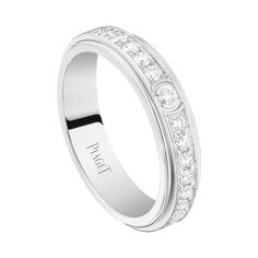 a white gold wedding ring with channeled diamonds on the side and an inscription that reads love