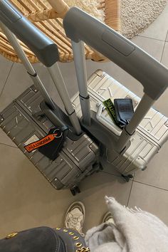 someone is standing next to their luggage on the floor