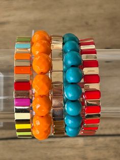 "Make a bold statement with our Dramatic Color Bracelet Stack. This stack of bracelets is sure to add a pop of color and personality to any outfit. Step up your style game with our unique and eye-catching accessory. Go ahead, wear them! Consists of 5 bracelets Eleanor Boxy Rainbow (one size only) Blue Wood 563 Esme Boxy Gold (one size only) Clementine Faceted 0000021 Red/Gold Boxy (one size only) *the three tile bracelets can not be adjusted. Contact us if you need a larger size and we can sugge Bold Adjustable Bracelets For Party, Bold Adjustable Party Bracelet, Adjustable Bold Bracelet For Parties, Adjustable Bold Party Bracelet, Trendy Stackable Beaded Bracelets, Trendy Colorful Party Bracelets, Bold Adjustable Bracelets As Gift, Trendy Stackable Bracelets For Party, Trendy Multicolor Stretch Bracelet For Party