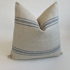 a beige pillow with blue stripes on it