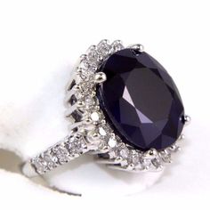 This Is A Fine Oval Cut Blue Sapphire Cocktail Ring W/Diamond Halo & Accents. It Is Made Of 100% Natural 14kt White Gold And Is In Brand New Condition. It Has A Ctw Of 13.36ct (1.24 Diamond/12.12 Sapphire) And Weighs 9.0 Grams. The Diamonds Have A Clarity Of Si1 And F Color. This Beautiful Custom Piece Has An Excellent Oval Cut Blue Sapphire Stone That Has Been Enhanced/Treated With Heating, Surrounded By A Diamond Halo With Accents Along The Band. Luxury Silver Diamond Ring With Sapphire, Luxury Silver Sapphire Diamond Ring, Luxury Silver Sapphire Ring In Platinum, Blue Sapphire Stone, Sapphire Cocktail Ring, Blue Sapphire Ring, Blue Sapphire Rings, Sapphire Stone, Diamond Halo