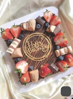 a cake with strawberries and chocolate on it