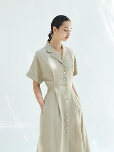 This is a trendy and modern dress by MOHAN that is made out of high quality and sturdy material. With distinctive mood of the design and comfortable wear, you can style it for your casual daily outfit.- Tuck detail on the waistline- Flared silhouette- Minimal and feminine mood Chic Linen Shirt Dress With Buttons, Casual Button-up Office Dress, Short Sleeve Midi Dress For Workwear In Relaxed Fit, Casual Dresses With Button Cuffs In Relaxed Fit, Casual Shirt Dress With Buttons For Workwear, Relaxed Fit Short Sleeve Midi Dress For Work, Beige Shirt Dress With Button Cuffs For Spring, Khaki Short Sleeve Dress With Relaxed Fit, Beige Short Sleeve Midi Dress For Work