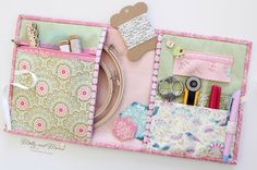 a pink and green case filled with lots of crafting supplies on top of a table